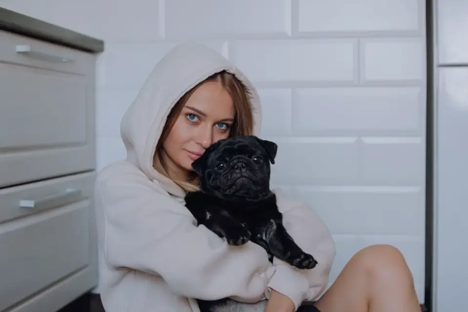 Owner and dog on floor together