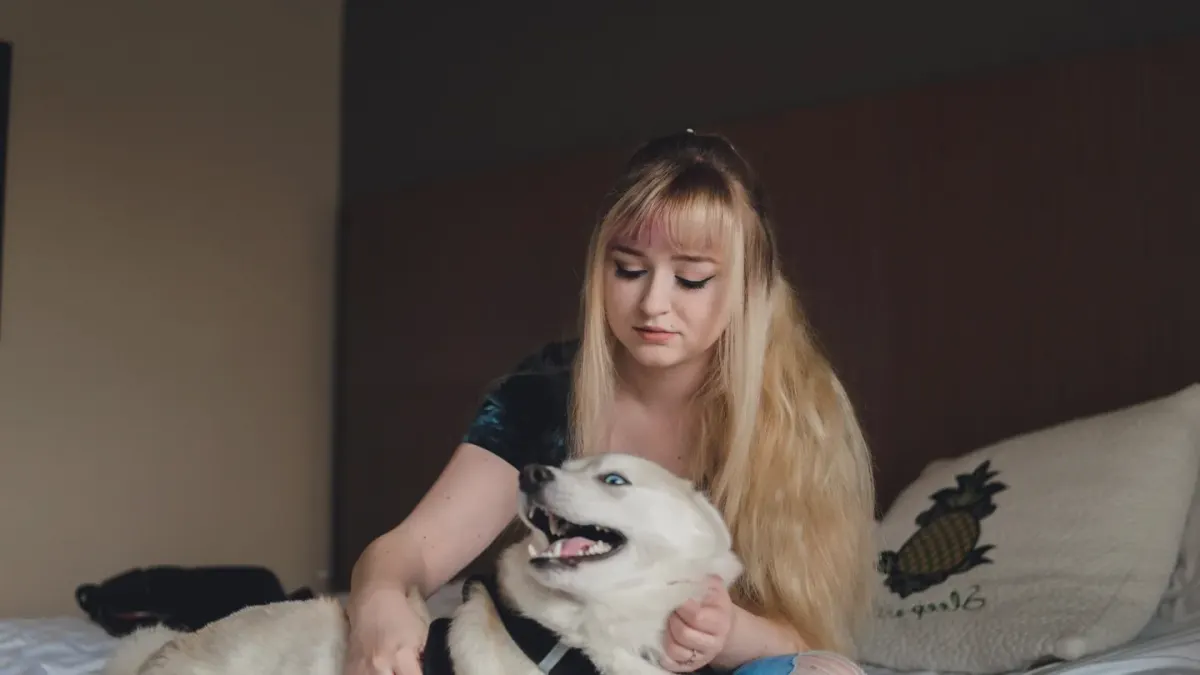 Owner and dog on floor together