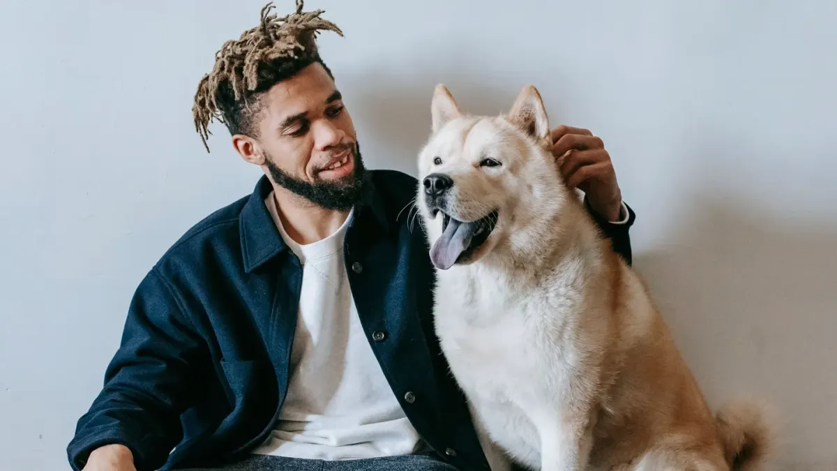 Owner and dog on floor together