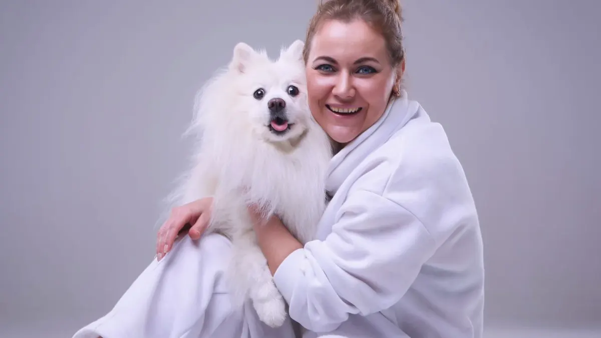 Owner and dog on floor together