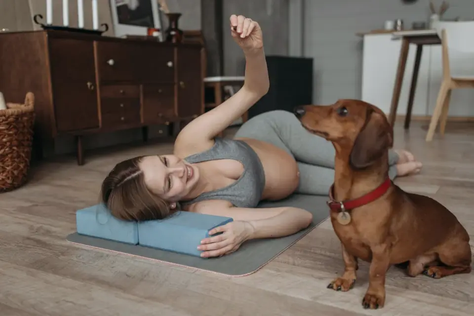Owner and dog on floor together