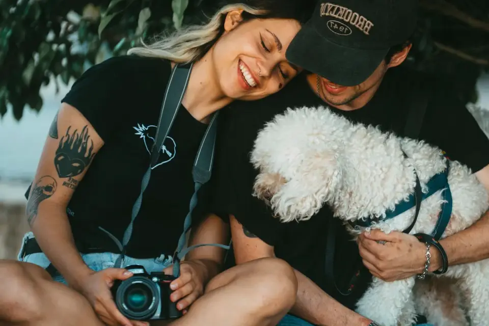 Owner petting dog on sofa